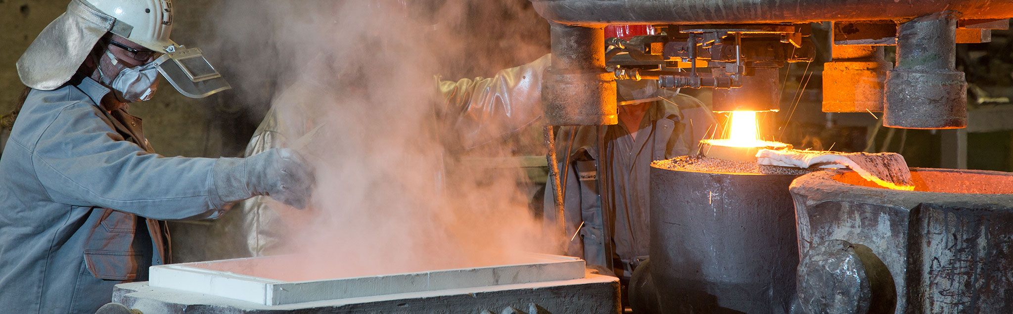 2 workmen producing a Nickel alloy ingot